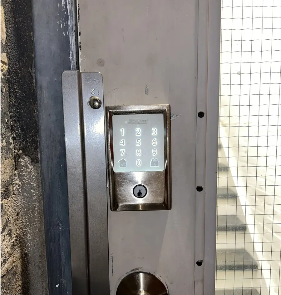 Touchscreen deadbolt on the back door. Press the checkmark to illuminate the screen. Enter your code and wait for the checkmark icon to flash before opening the door. The door will take 3 to 4 seconds to finish unlocking, so be patient. To lock the door, press the lock icon.