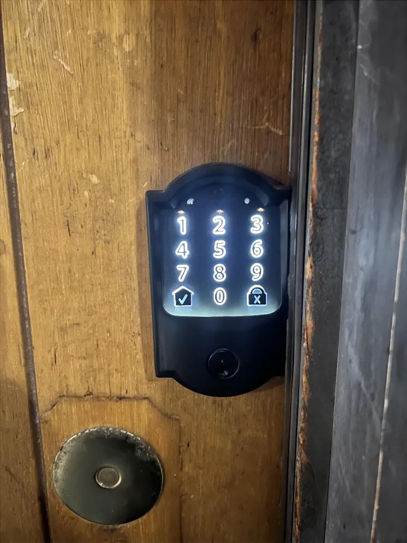 Touchscreen deadbolt on the front door. 1. Press the checkmark to illuminate the touchscreen. 2. Enter your code. Wait for the checkmark icon to flash before opening the door. 3. To lock the door, press the lock icon.