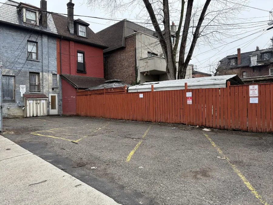 The back parking lot. Enter the back door on the left. Parking spot number 4 is on the right.