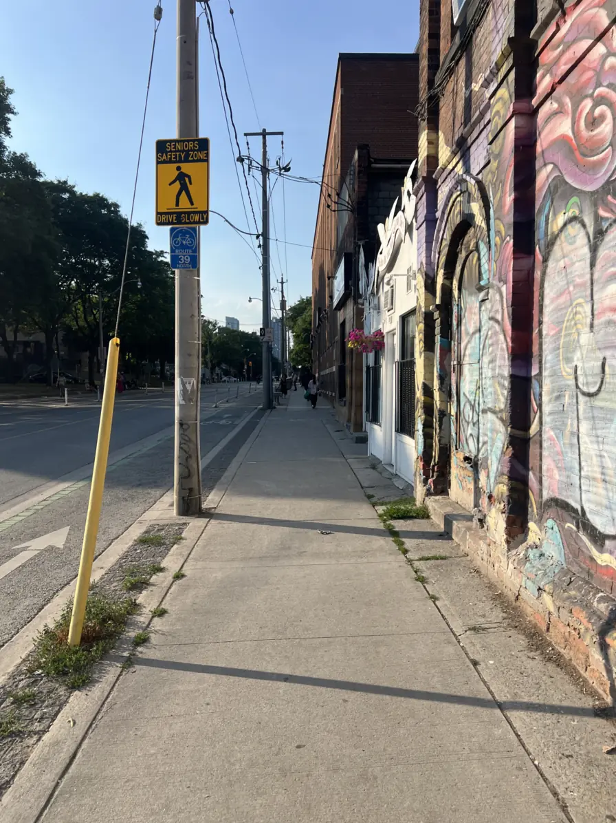 The sidewalk on Sherbourne Street. Turn right at the first alley.