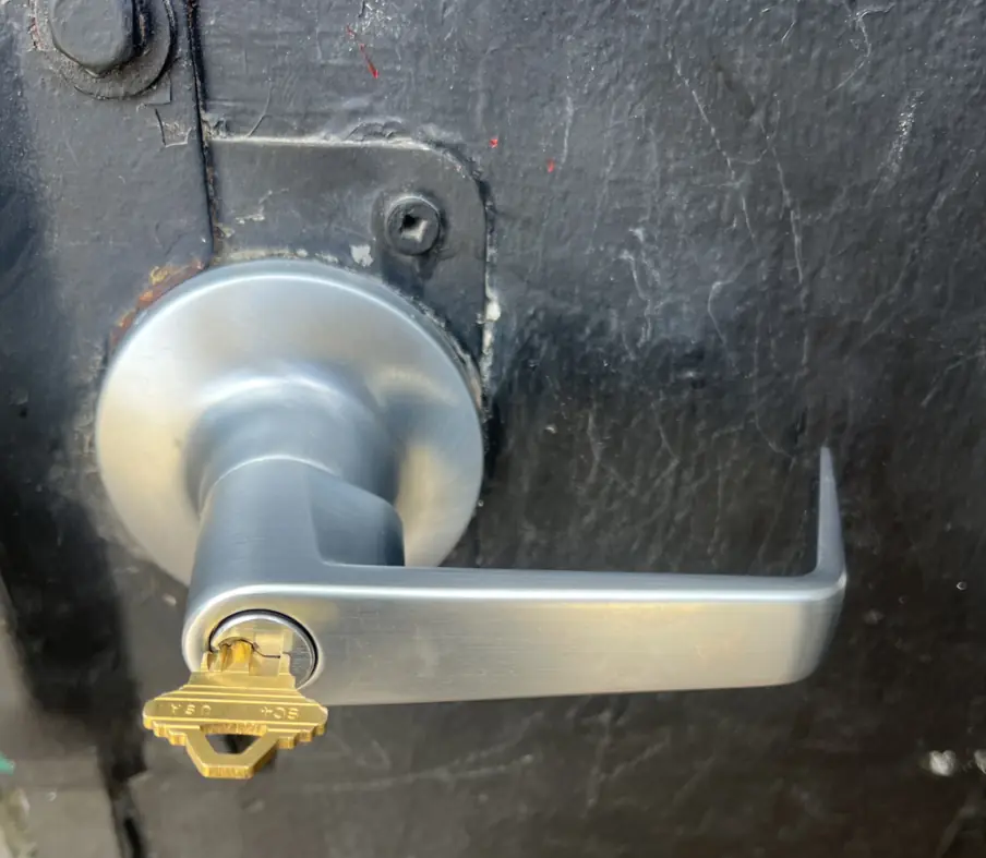 The building front door lever with the key in the lock. Check the lever is straight before trying to remove the key.